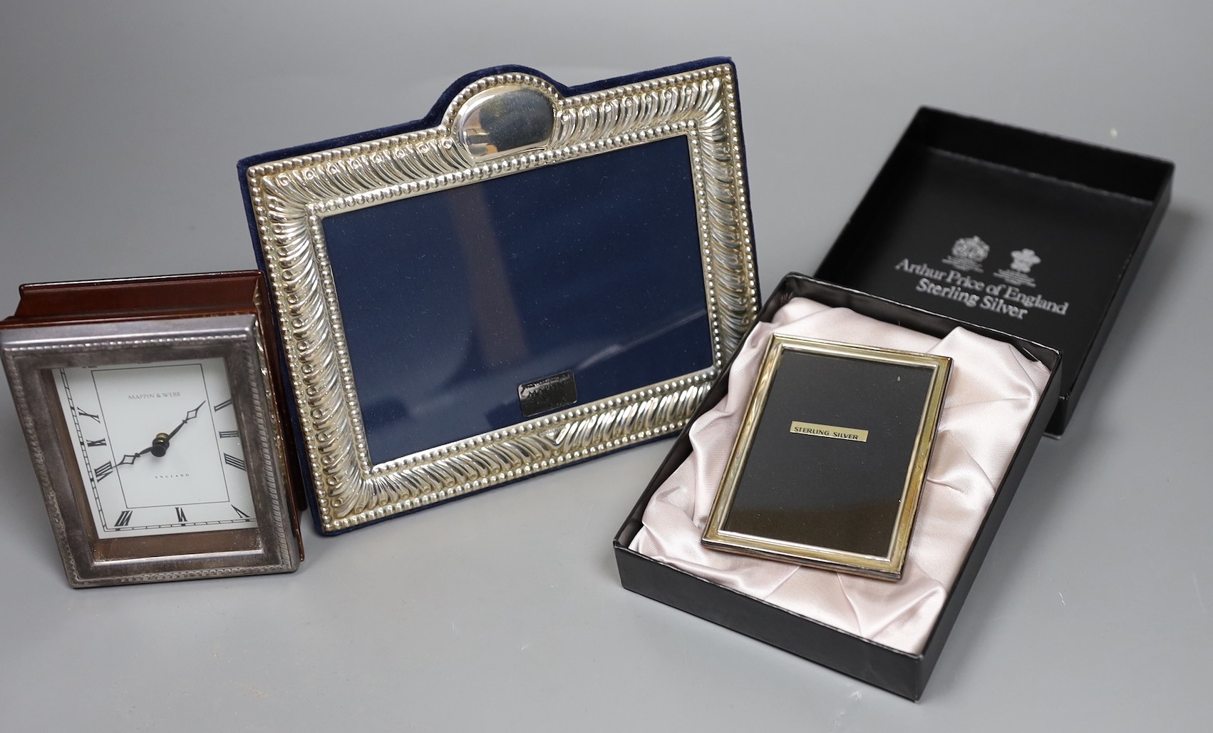 Two modern silver mounted photograph frames and a similar silver mounted Mappin & Webb timepiece, 10.6cm.
